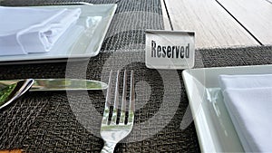 The table sign sits on a placemat made of black woven materia