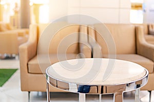 Table and sofa in waiting area of luxury hospital