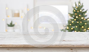 Table space in front of defocused window sill with christmas tree photo