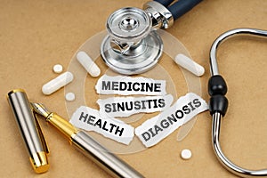 On the table is a stethoscope, pills and pieces of paper with inscriptions - HEALTH, MEDICINE, DIAGNOSIS, SINUSITIS