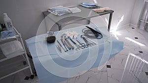 A table with surgical sterile instruments, scalpels and clamps. Action. Details of the operating room, prepared clean