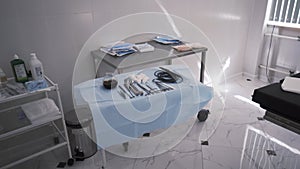 A table with surgical sterile instruments, scalpels and clamps. Action. Details of the operating room, prepared clean