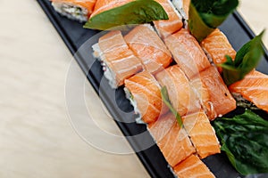 On table sushi roll food fish philadelphia japanese salmon delicious sushi rice cucumber meal traditional wasabi fresh healthy