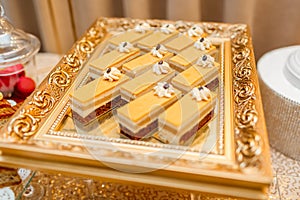 Table with sweets and goodies for the wedding party reception, decorated dessert table. Delicious sweets on candy buffet