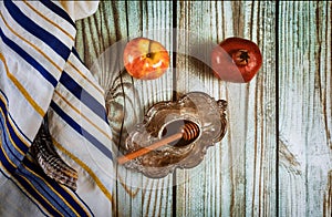 On the table in the synagogue are the symbols of Rosh Hashanah apple and pomegranate, shofar talith