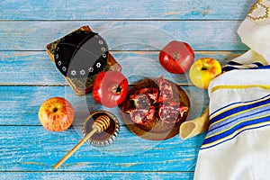 On the table in the synagogue are the symbols of Rosh Hashanah apple and pomegranate, shofar talith