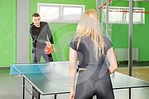 Table tennis. man and woman compete in a ping pong game. horse competition