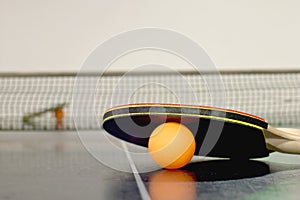 Table tennis or ping pong rackets and balls on table
