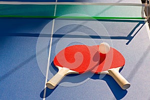 Table tennis ping pong two paddles and white ball photo