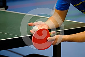 Table tennis player serving