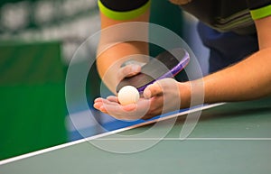 Table tennis player serving