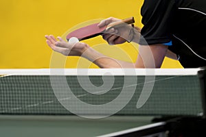 Table tennis player serving