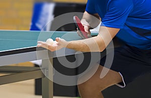 Table tennis player serving