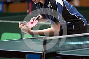 Table tennis player serving