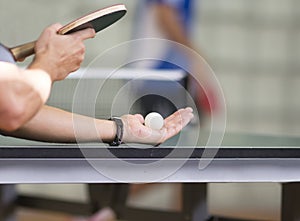 Table tennis player serving