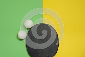 Table tennis racket and balls on yellow green background