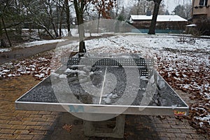 A table tennis table under the snow in a recreation area for Berliners in winter. Berlin, Germany