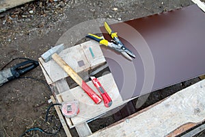 A table with tools and a piece of wood