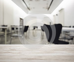 Table top with blurred office working space interior background