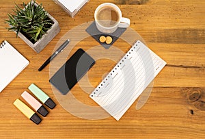 Table Top desk view with pencil a plant, coffee, workspace, mobile display and laptop