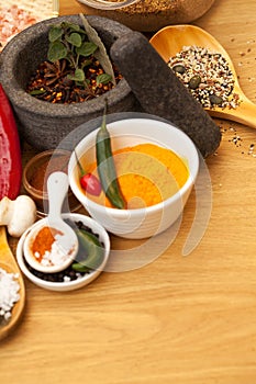 Table top, mortar and food spices for cooking gourmet meal, turmeric seasoning or flavor pestle. Pepper vegetables