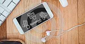 Table top with a phone with web graphics on the screen