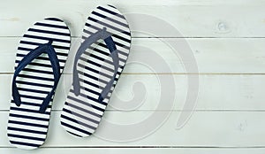 Table top view of accessory for travel on summer holiday background concept.Flat lay of blue slippers on modern rustic white