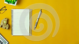 Table top view aerial image stationary on office desk background concept.Flat lay objects the blank space on the notebook with pen