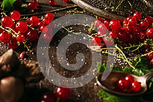 Table top view on a bunch of red currant on a dark wooden table