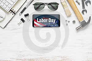 Table top view of labor day abstract background concept. Flat lay mockup smartphone with Happy Labor Day USA Holiday and essential