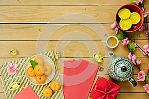 Table top view Lunar New Year & Chinese New Year vacation concept background.Flat lay orange in wood basket & pink cherry blossom