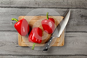 Table top view - three bright red bell peppers, water drops, wit