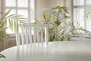 Table top with a white chair and space for products with nice bright home interior.