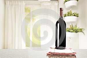 Table top with a wine bottle and space for products with nice bright home interior.