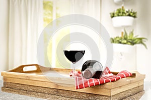 Table top with a wine glass and space for products with nice bright home interior.