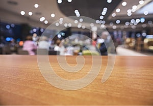 Table top wooden counter Interior shop cafe restaurant lighting with people sitting background
