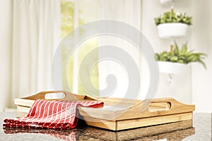 Table top with a wooden tray and space for products with nice bright home interior.