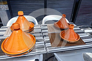 Table with traditional ceramic tagines in street cafe in Marrakesh. Morocco,  North Africa