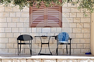 Table with two chairs in front of house