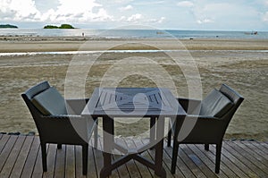 A table with two chairs on lath floor