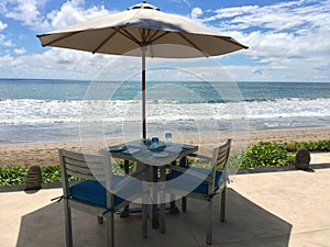 Table with two chairs near sea