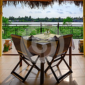 Beautiful view from table in Vietnamese restaurant to tributary river of Mekong River, near Ho Chi Minh City, Vietnam photo