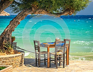 Table under the three by the blue sea