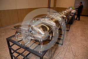 Table with utensils and mirror boilers for meal . a closeup photo of dishware for a restaurant . Lamb Lamb stewed . Chicken breast