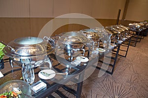 Table with utensils and mirror boilers for meal . a closeup photo of dishware for a restaurant . Lamb Lamb stewed . Chicken breast