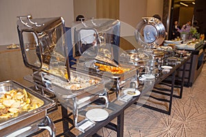 Table with utensils and mirror boilers for meal . a closeup photo of dishware for a restaurant . Lamb Lamb stewed . Chicken breast