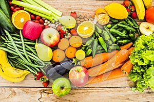 Table view of coloured mix of fresh and seasonal fruits and vegetables for vegan or vegetarian or just heathy food - diet and