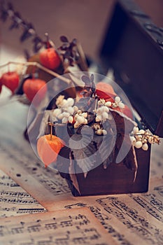 Table with wedding autumn decor - candles, books, clocks, flowers, notes