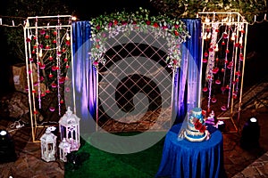 Table with a wedding cake, candles, light and flowers. wedding decoration