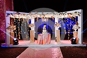 Table with a wedding cake, candles, light and flowers. wedding decoration